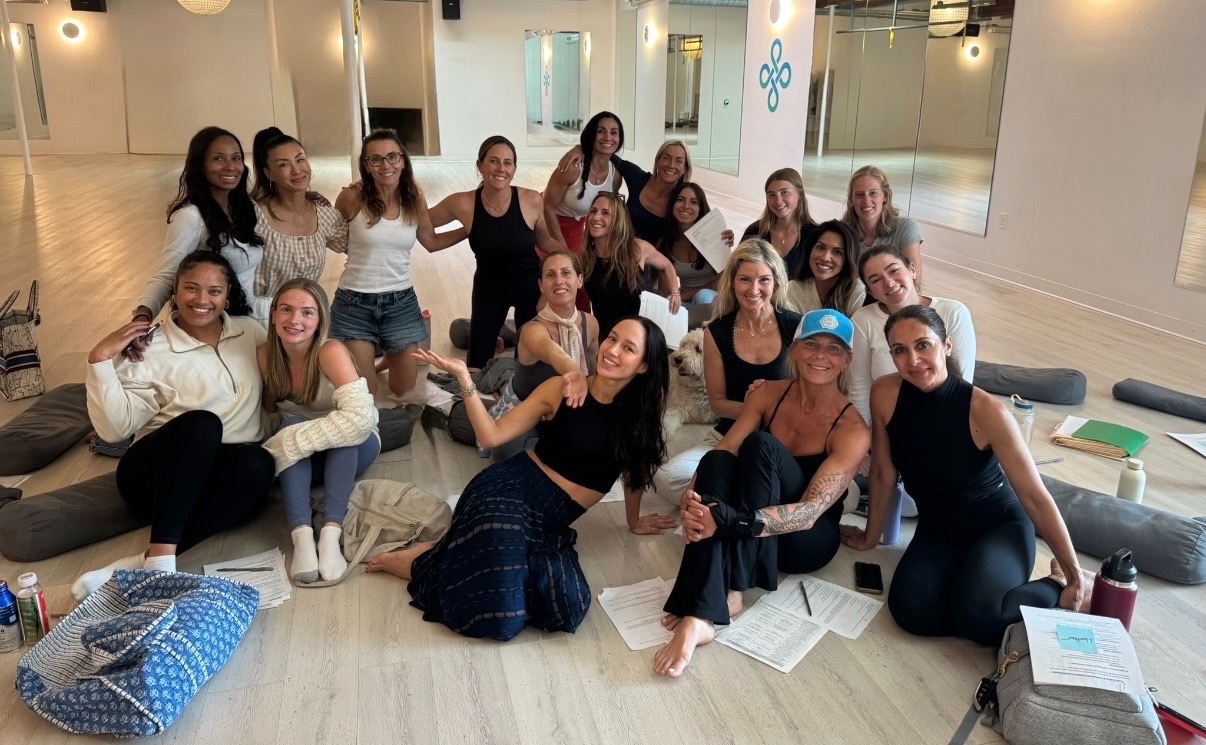 NOW Power Yoga teachers gathered together in the studio