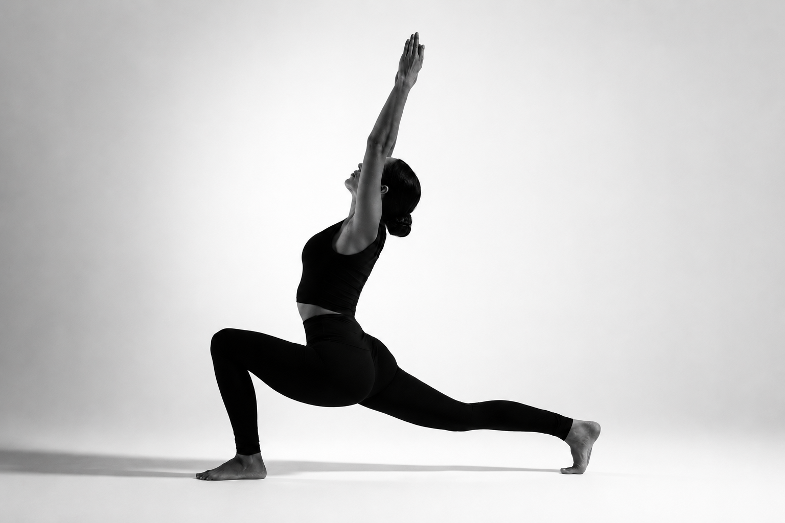 Woman in a strong crescent lunge with arms reaching overhead